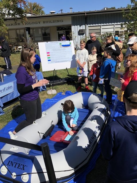 A scientist volunteer in the Biology and Paleo Environment exhibit shows visitors a raft similar to the ones they use when heading out to take core samples from the bottoms of lakes. Photo: Phebe Pierson A scientist volunteer in the Biology and Paleo Environment exhibit shows visitors a raft similar to the ones they use when heading out to take core samples from the bottoms of lakes. Photo: Phebe Pierson