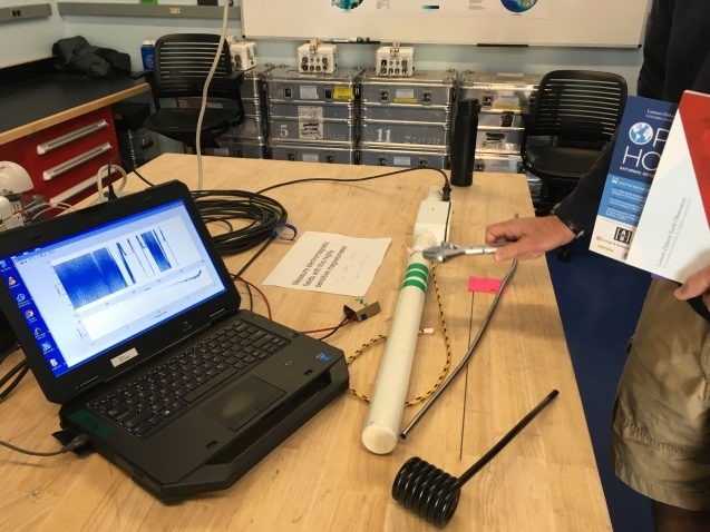 A visitor waves a wrench to disrupt the readings from a magnetometer, which researchers in Lamont’s Electromagnetic Geophysics Lab use to measure the electrical conductivity through the earth. This information, combined with magnetic field measurements, has helped the team to study water flow under the Antarctic ice sheet and to discover a freshwater aquifer under the sea. Photo: Sarah Fecht