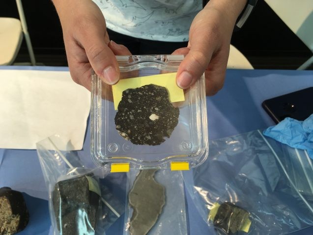 One exhibit let visitors touch rocks from outer space. Shown here is a slice of a meteorite that sprayed off of the moon during a collision and later landed on Earth. Photo: Sarah Fecht