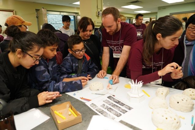 Each coral gives a detailed estimate of the climate over a period of hundreds of years. With grad student Jonathan Lambert’s assistance, kids used straws to take cores from dough with multi-colored layers. The kids counted the layers to determine how old each “coral” would be in real life, and learned about how important corals are in reconstructing the ancient history of Earth’s climate. Photo: Kyu Lee kids use straws to take cores from dough with multi-colored layers