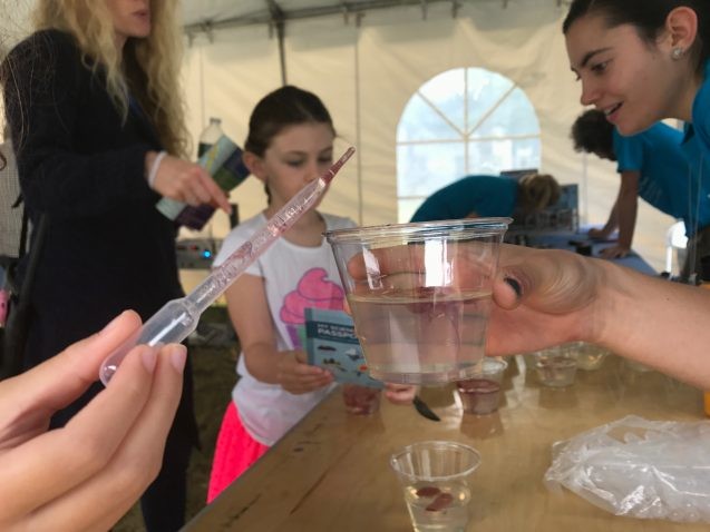 By cutting gelatin and injecting juice into the cracks, kids learned how fracking and wastewater injection can cause earthquakes. Photo: Kyu Lee person taking water out of a cup using a dropper