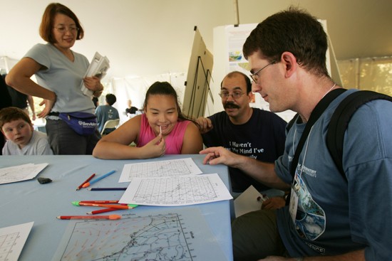 family and researcher draw a map
