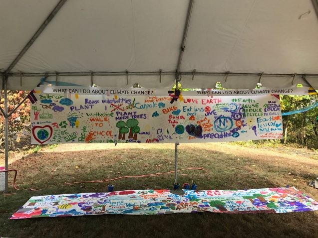 Open House attendees made murals to answer the questions “How does climate change affect me?” and “What can I do about climate change?” Photo: Sarah Fecht painted collaborative mural