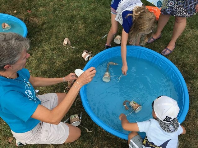 Fishing for plankton using nets made from coffee cups and pantyhose. Photo: Sarah Fecht children fishing for plankton in a plastic pool