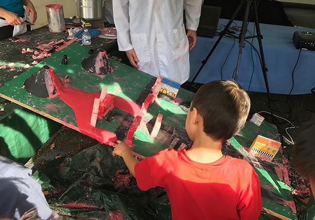 Kids set up barriers to try to protect a town from a volcanic eruption of hot wax. Photo: Sarah Fecht Kids set up barriers to try to protect a town from a volcanic eruption of hot wax