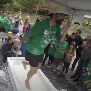 Image of scientist running in place in a bathtub full of cornstarch